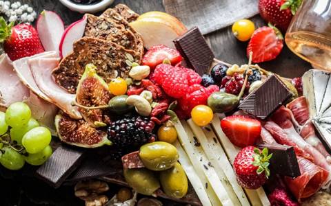 https://static1.therecipeimages.com/wordpress/wp-content/uploads/2022/03/Anto-Meneghini-on-Unsplash-colorful-charcuterie-board-with-seasonal-fruits-cheese-olives-and-chocolate.jpg?q=50&fit=crop&w=480&h=300&dpr=1.5